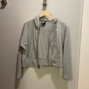 Nike woman’s gray zip up sweatshirt. But it doesn’t zip up